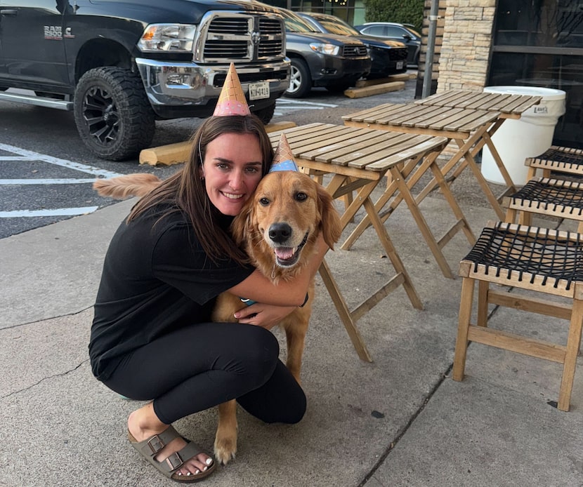 Sarah Gaither, 27, smiles while hugging a dog in Dallas. Gaither's flight back home to...