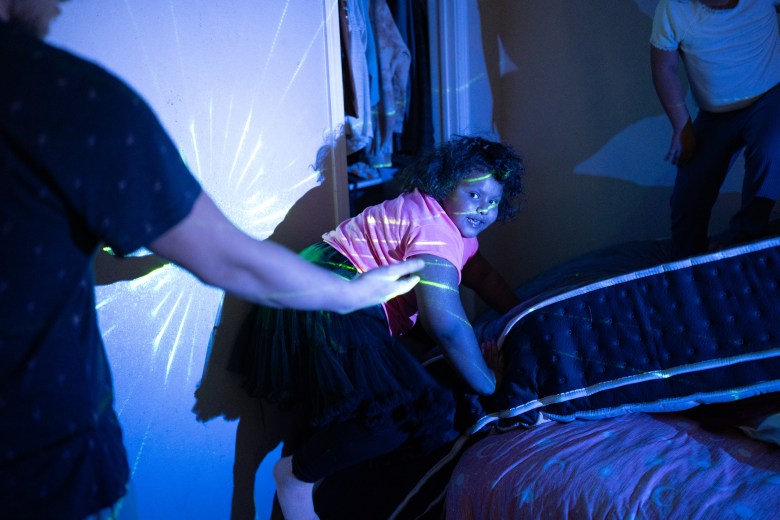 Seven-year-old Freyja Radtke, who suffers from Bardet-Biedl syndrome, a condition which causes excessive weight gain and hormonal imbalances, and in her particular case, an inability to control her own appetite, plays with her father, Sean Radtke, and sister Morrigan, 5, at the family’s home on Saturday, February 28, 2026 in El Paso, Texas. Because Freyja is due for a medical test next week, she is forced to be off of Imcivree, the medication that controls her hormonal imbalances that lead to excessive hunger, until after the test.