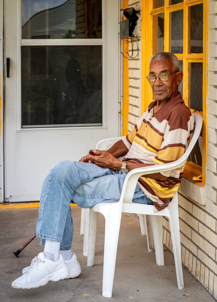 James Warren sitting on the front porch of his home in South Dallas at about 12:40 p.m. May 10, 2025. Warren said he served in the Korean War and had lived in the same house for more than sixty years.