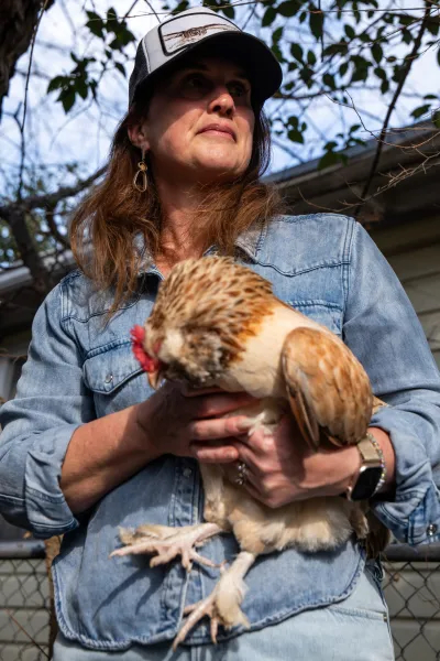 Ashley Fairleigh with one of her hens at her home in Austin on March 6, 2026.