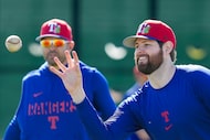 Texas Rangers pitcher Jordan Montgomery catches a ball while assisting coaches run a...