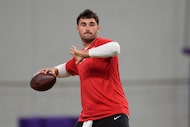 Minnesota Vikings quarterback Sam Howell takes part in drills during an NFL football team...