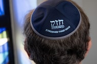 Jeffrey Cohen wears his “Stronger Than Hate” kippah as he poses for a photo in the sanctuary...