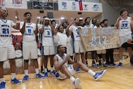 North Crowley players pose for a team photo after their 52-49 victory over Duncanville to...
