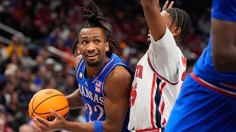 Kansas' Darryn Peterson (22) looks past Houston's Mercy Miller during...