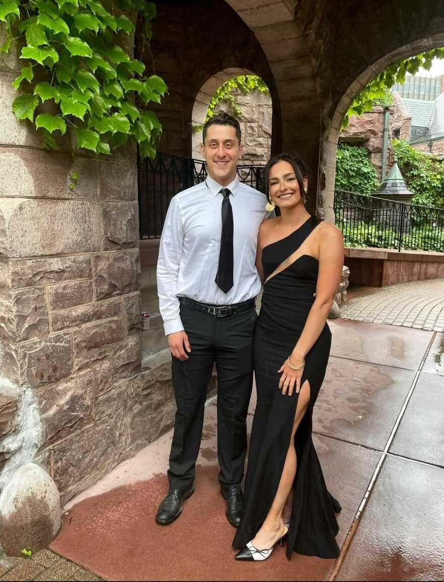 Jorge Pederson and Olivia Caspers pose for a photo in elegant clothes.