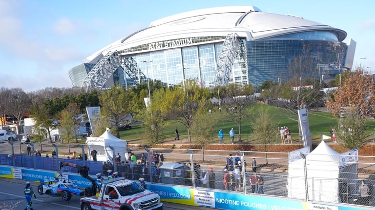 Emergency crew moves driver Josef Newgarden's car after he hit...