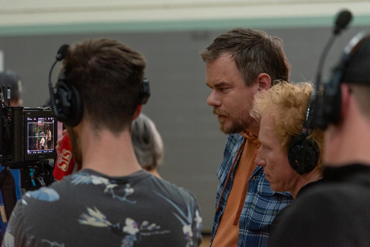 A director looks at a monitor on a film set.