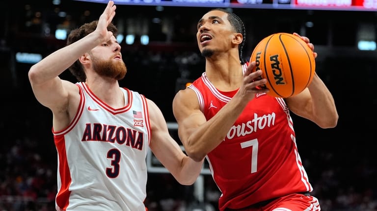 Houston's Milos Uzan (7) heads to the basket past Arizona's...