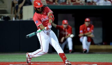 Tyler Cox salutes the bullpen while rounding the bases.