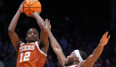 Texas guard Tramon Mark (12), left, scores a go-ahead basket with 1 second remaining during the second half in a First Four college basketball game in the NCAA Tournament against North Carolina State, Tuesday, March 17, 2026, in Dayton, Ohio. (AP Photo/Kareem Elgazzar)