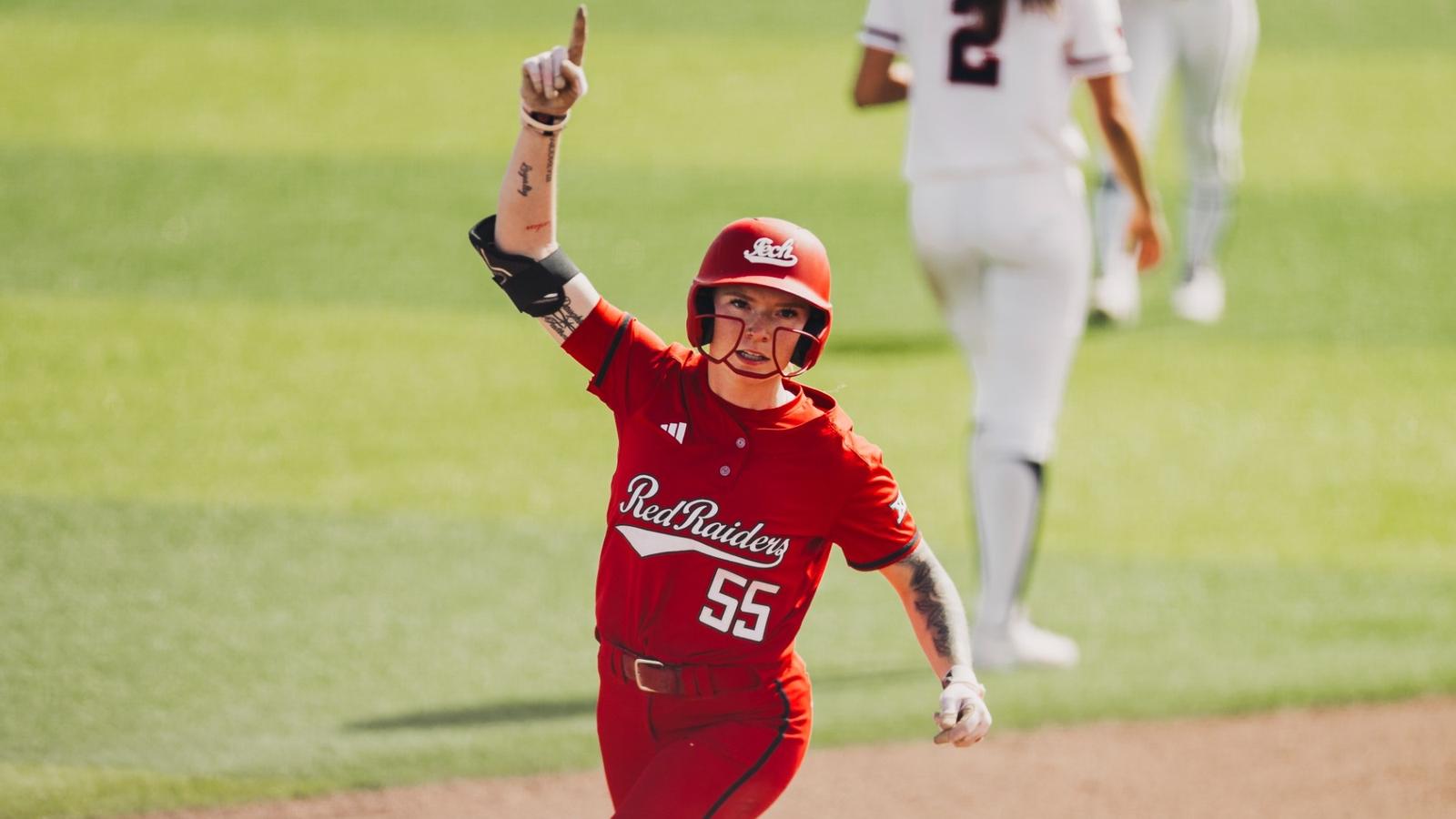 Desirae Spearman rounding third base high fiving coach gerry glasco after hitting a home run