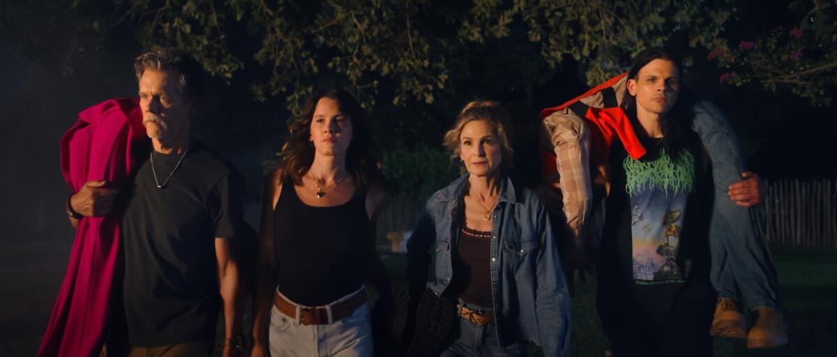 An extended family stands together at night.