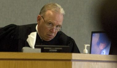 Mike McCall, right, and his wife Amanda McCall, left, pick up toys in the living room of their South Austin home on Friday, March 13, 2026.