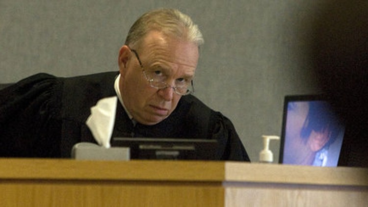 Mike McCall, right, and his wife Amanda McCall, left, pick up toys in the living room of their South Austin home on Friday, March 13, 2026.
