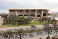 Vehicles pass along Young St. overlooking Dallas City hall  on Friday, Feb. 20, 2026, in...