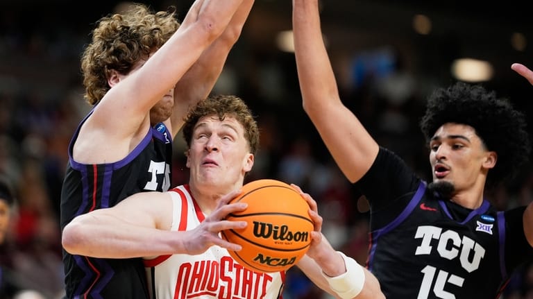 Ohio State center Christoph Tilly drives to the basket between...
