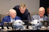 Dallas Cowboys owner Jerry Jones (left) listens to his grandson and pro college scout Shy...