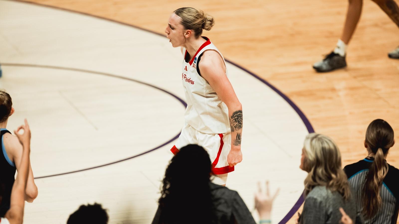 The Lady Raiders surround Bailey Maupin after her postgame TV interview, celebrating Texas Tech's opening round win of the NCAA Tournament over Villanova.