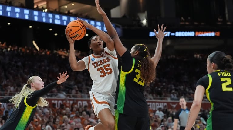 Texas forward Madison Booker (35) drives to the basket against...