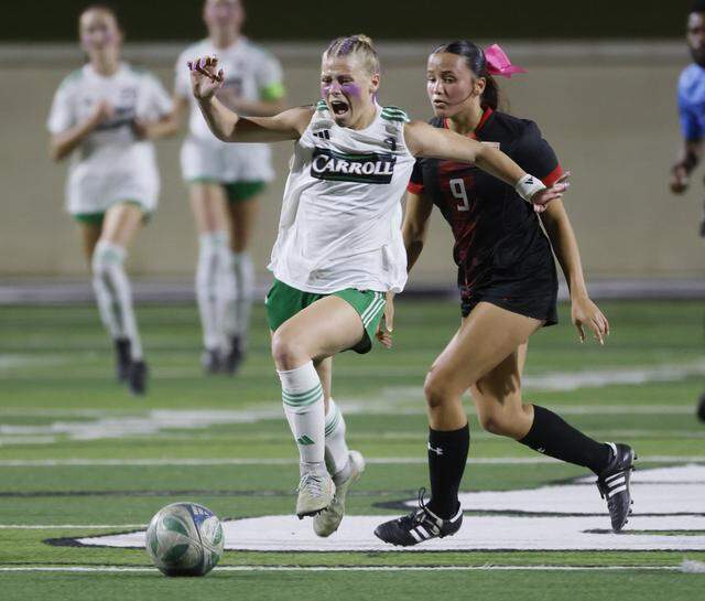 Southlake Carroll forward Caroline Holcombe brings the ball down the pitch ahead of Mansfield Legacy defender Bella Baker during the second half of a UIL bi-district round soccer playoff game at Crowley ISD Multi-Purpose Stadium in Fort Worth, Texas, on Friday, March, 20, 2026.