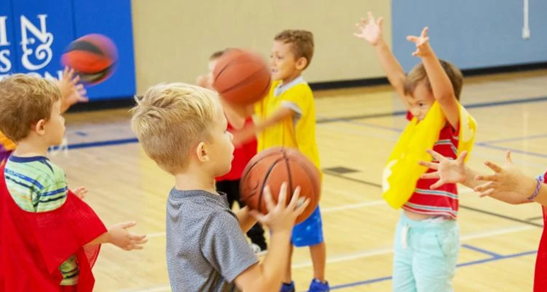toddlers passing basketballs