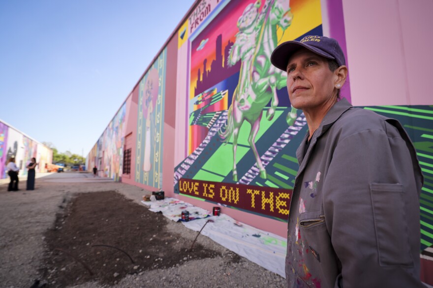Kim Brewer is one of artists working on The Art Docks project Tuesday, March 24, 2026, in Dallas. The mural installation includes 18 murals in an industrial alleyway in the Design District.