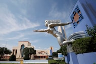 Sculptures along the Esplanade Fountain at Fair Park in 2024. A revised contract with Visit...
