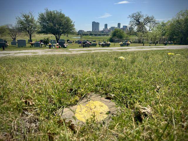 A simple stone with a yellow circle at Oakwood Cemetery marks the grave of an Indigenous woman whose remains were discovered during construction in downtown Fort Worth in 2016. Before she was buried in December 2017, experts determined she had been in her 30s when she died more than 1,000 years ago.