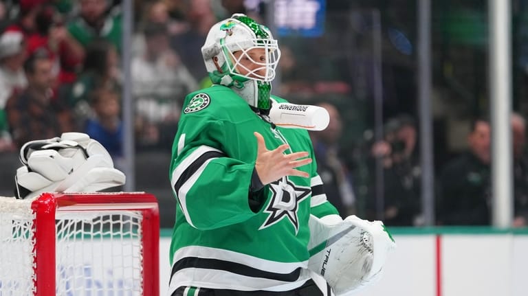 Dallas Stars goaltender Casey DeSmith flips a bottle as he...