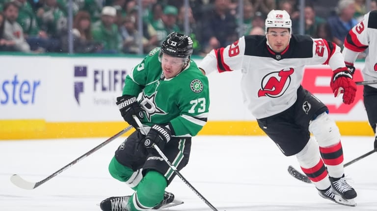 Dallas Stars left wing Adam Erne (73) is tripped up...