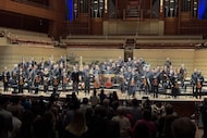 Foreground, guest conductor Daniele Rustioni and violin soloist Alexi Kenney acknowledge a...
