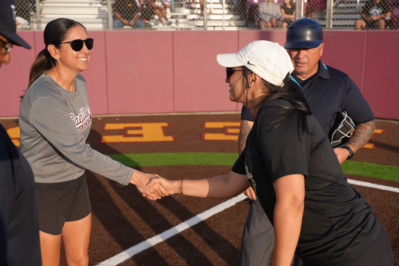 Calallen softball head coach Teresa Lentz shakes hands with T-M head coach Sally DeLeon