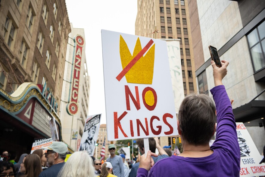 No Kings protest demostrators march along N St. Mary's Street waving their signs on March 28, 2026