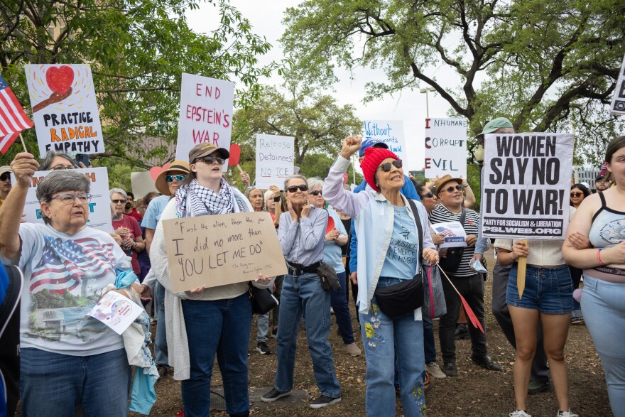 No Kings demonstrators sing along at Travis Park before the march