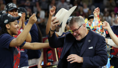 UConn Huskies players celebrate with head coach Geno Auriemma after defeating Notre Dame 70-52 in the Elite Eight of the 2026 NCAA Women's Basketball Tournament at Dickies Arena on March 29, 2026 in Fort Worth, Texas.