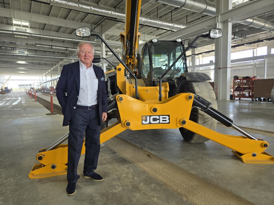 Lord Anthony Bamford, chair of JCB, poses next to equipment made by the company during a tour of its future San Antonio plant on March 30, 2026