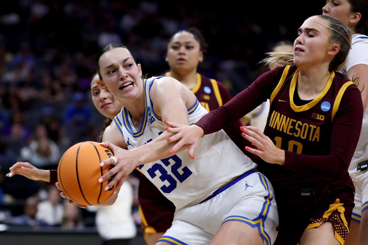 UCLA forward Angela Dugalic looks to pass around Minnesota guard Mara Braun during a Sweet 16 game on Friday.