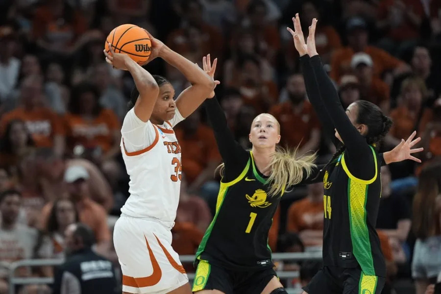 Texas forward Madison Booker (35) is pressured by Oregon forward Mia Jacobs (1) and guard Ari Long (14) during the first half in the second round of the NCAA college basketball tournament, Sunday, March 22, 2026, in Austin, Texas. (AP Photo/Eric Gay)