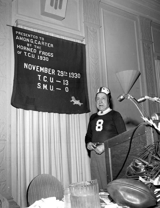 Amon Carter, the creator and publisher of the Fort Worth Star-Telegram, wearing a TCU jersey and helmet given to him by Horned Frogs football player Davey O’Brien, on April 13, 1950.