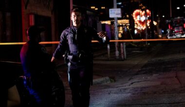 Night image of an Austin, Texas, police officer at a homicide scene outside a bar