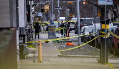Police tape and police officers can be seen outside a bar.