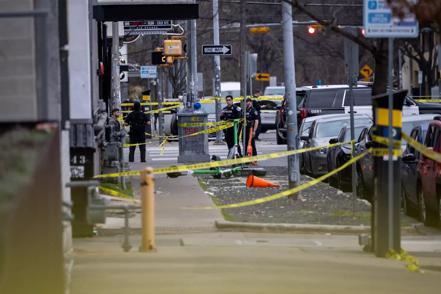 Police tape and police officers can be seen outside a bar.