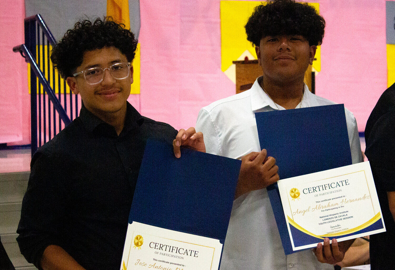 Jose (Tony) and Angel holding up their honors at the board meeting in Anthony.