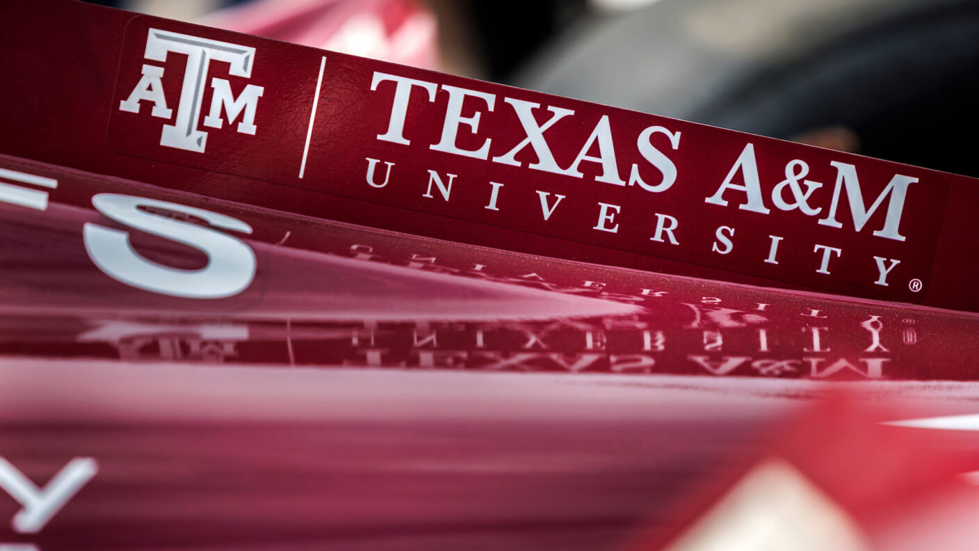 Piece of the Texas A&M branded IndyCar vehicle that says Texas A&M University