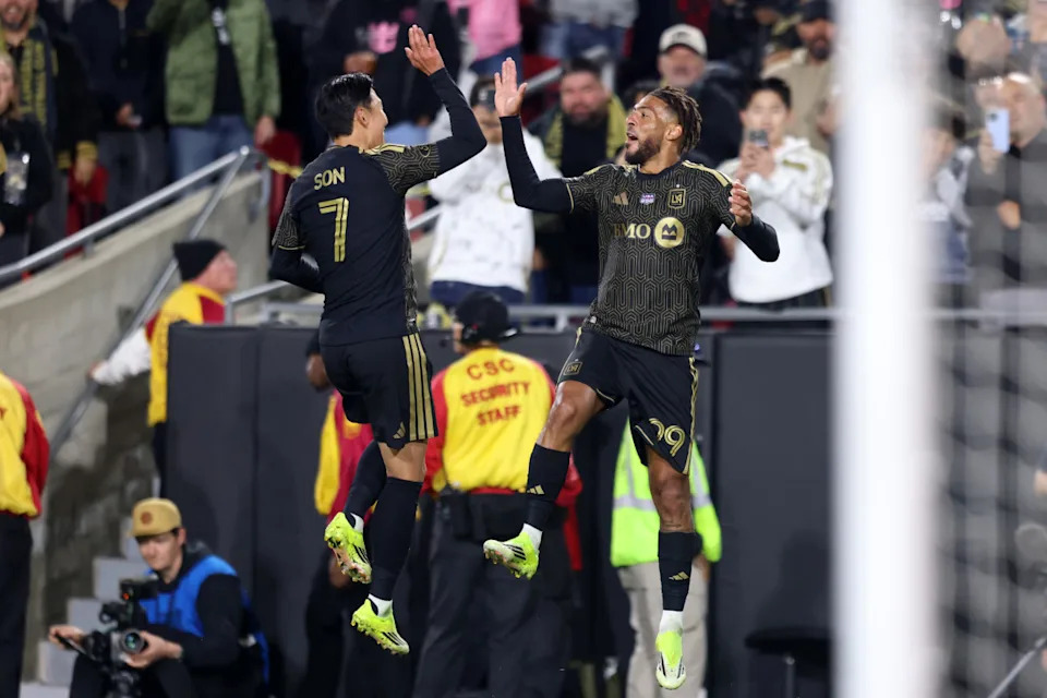 Denis Bouanga #99 of Los Angeles FC celebrates with teammate Son Heung-Min #7 after scoring the team's second goal during the MLS match between Los Angeles Football Club and Inter Miami CF at Los Angeles Memorial Coliseum on February 21, 2026, in Los Angeles, California.Photo by Luiza Moraes&sol;MLS via Getty Images