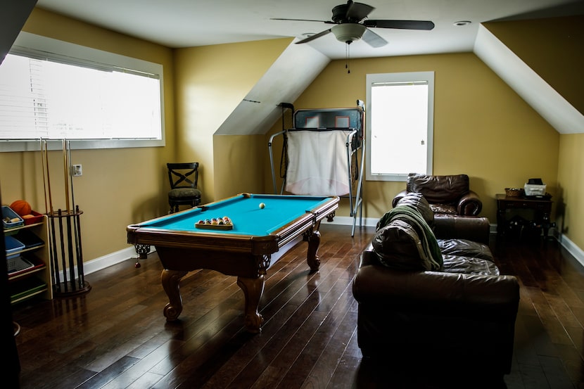 Yellow gold upstairs bonus room done with pool table. Man cave. Recreation room.
