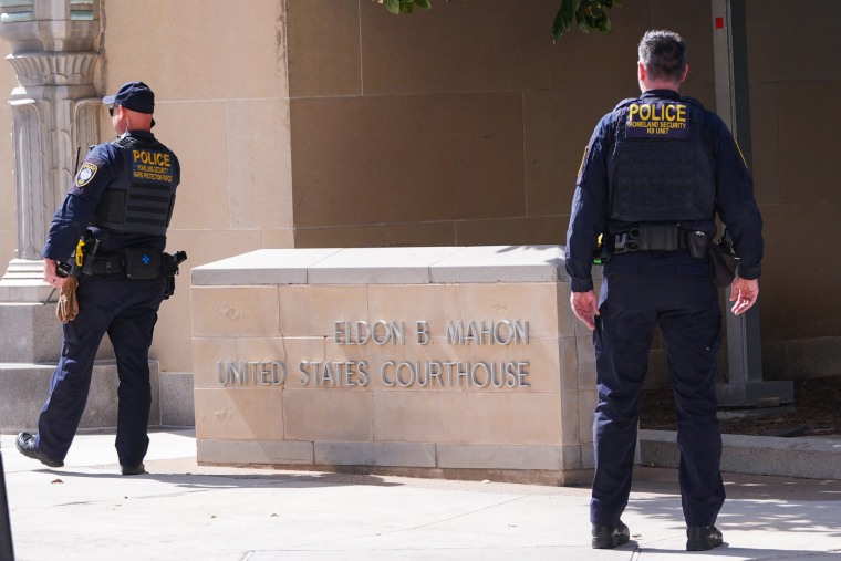 Department of Homeland Security officers stand outside the Eldon B. Mahon U.S. Courthouse.