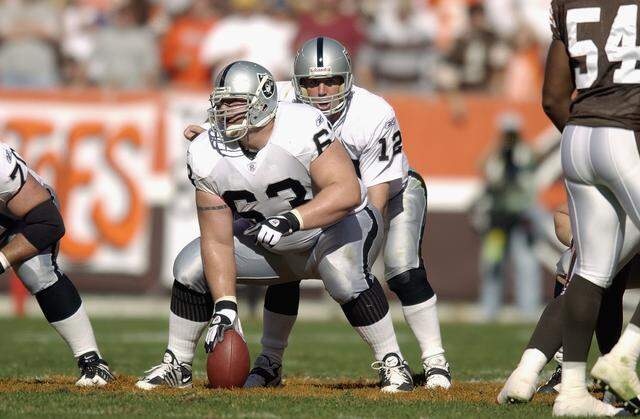 CLEVELAND, OH - OCTOBER 12: Center Barret Robbins #63 of the Oakland Raiders gets set to snap the ball to quarterback Rich Gannon #12 during the game against the Cleveland Browns on October 12, 2003 at Cleveland Browns Stadium in Cleveland, Ohio. The Browns defeated the Raiders 13-7 (Photo by David Maxwell/Getty Images)