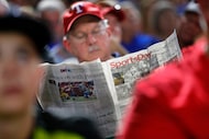 A Texas Rangers fan reads SportsDay during the fifth inning of the Rangers Los Angeles...